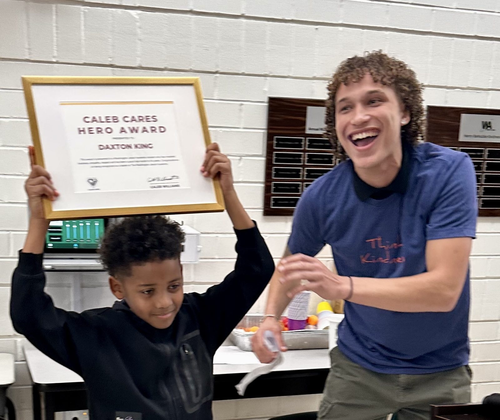 A young Hero Award winner beaming with his certificate