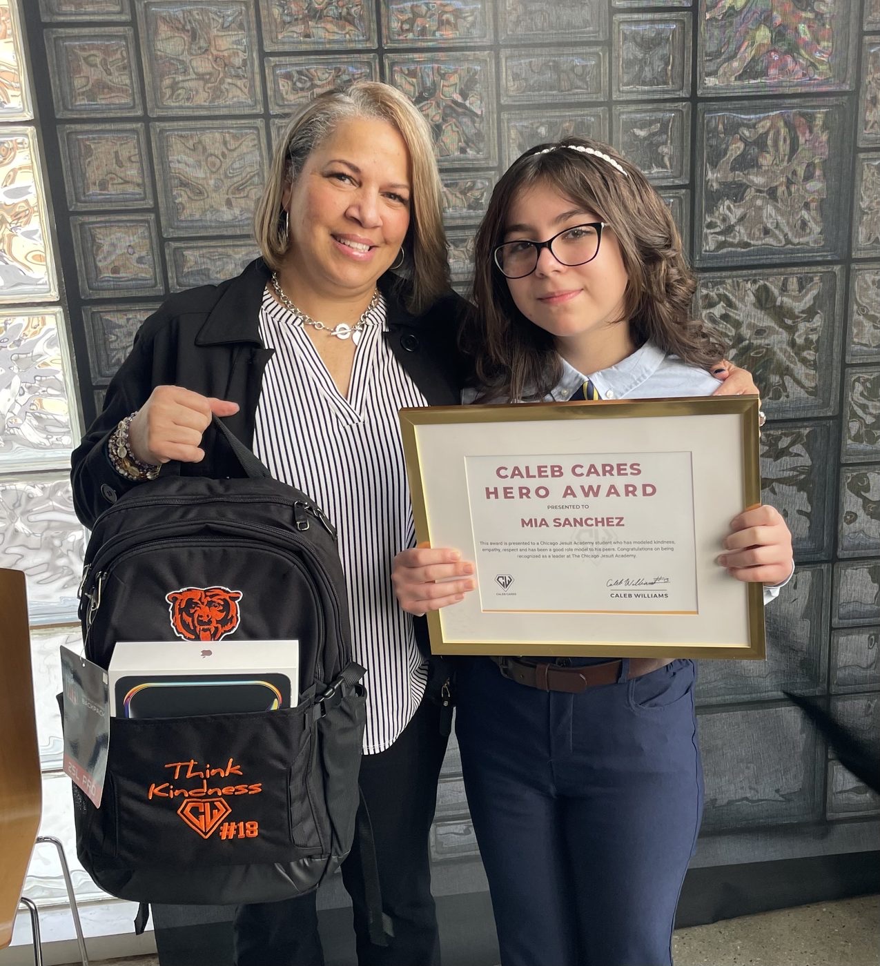 Hero Award winner Mia with her certificate and Think Kindness backpack