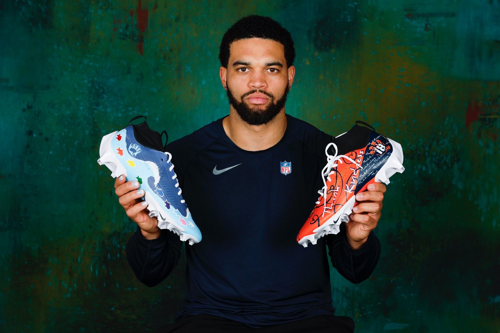 Caleb presenting colorful shoes at a youth event