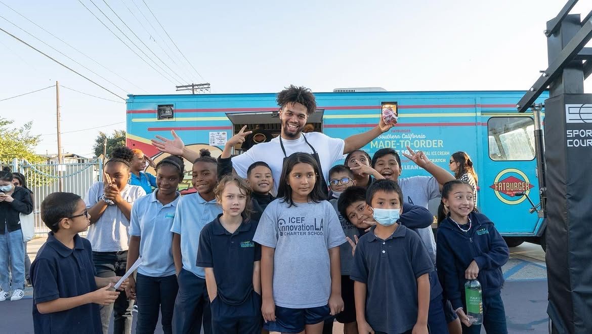 Caleb with children at a community food truck event