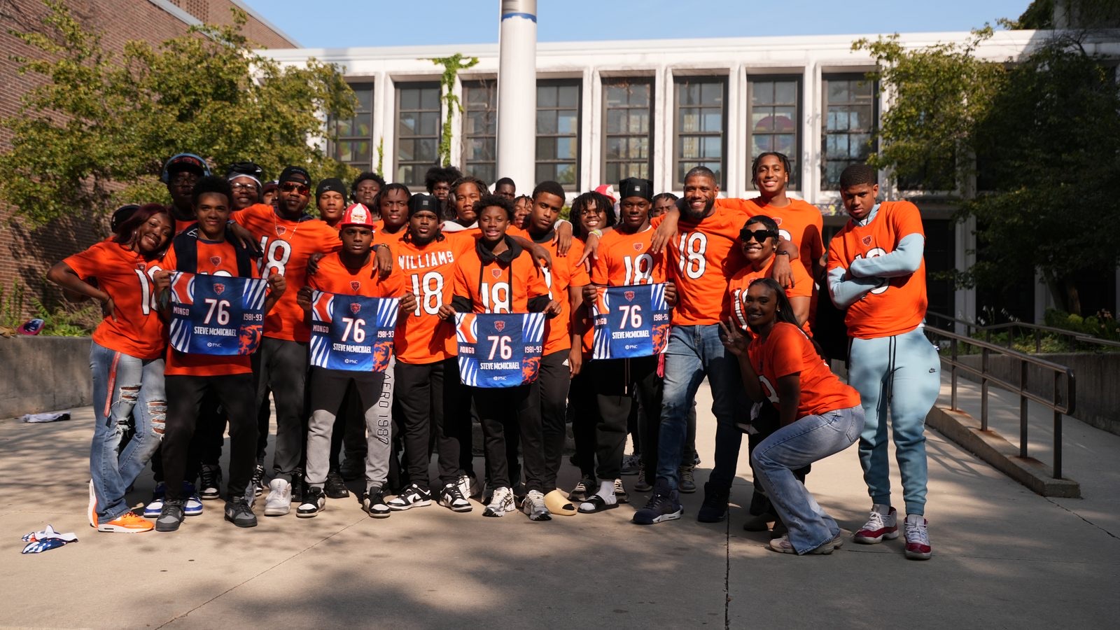 Group in orange jerseys honoring Steve McMichael