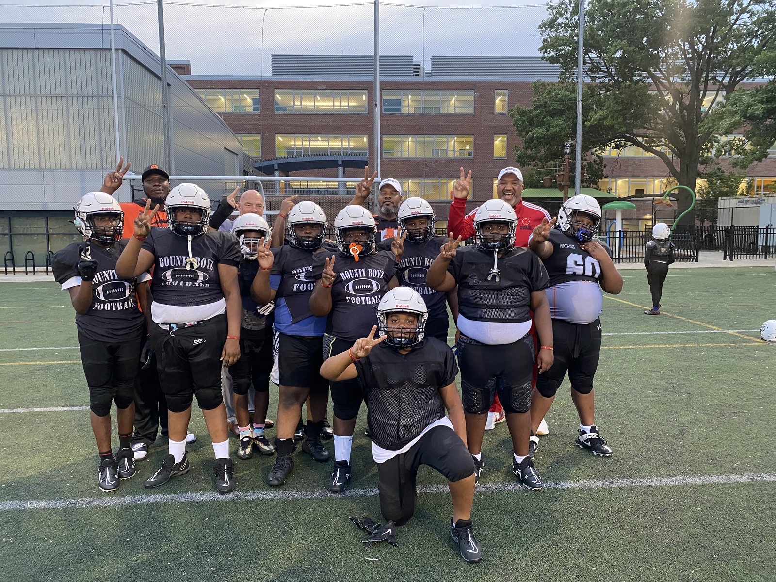 Young football players and coaches on the field