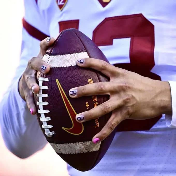 Caleb holding a football, mental health program