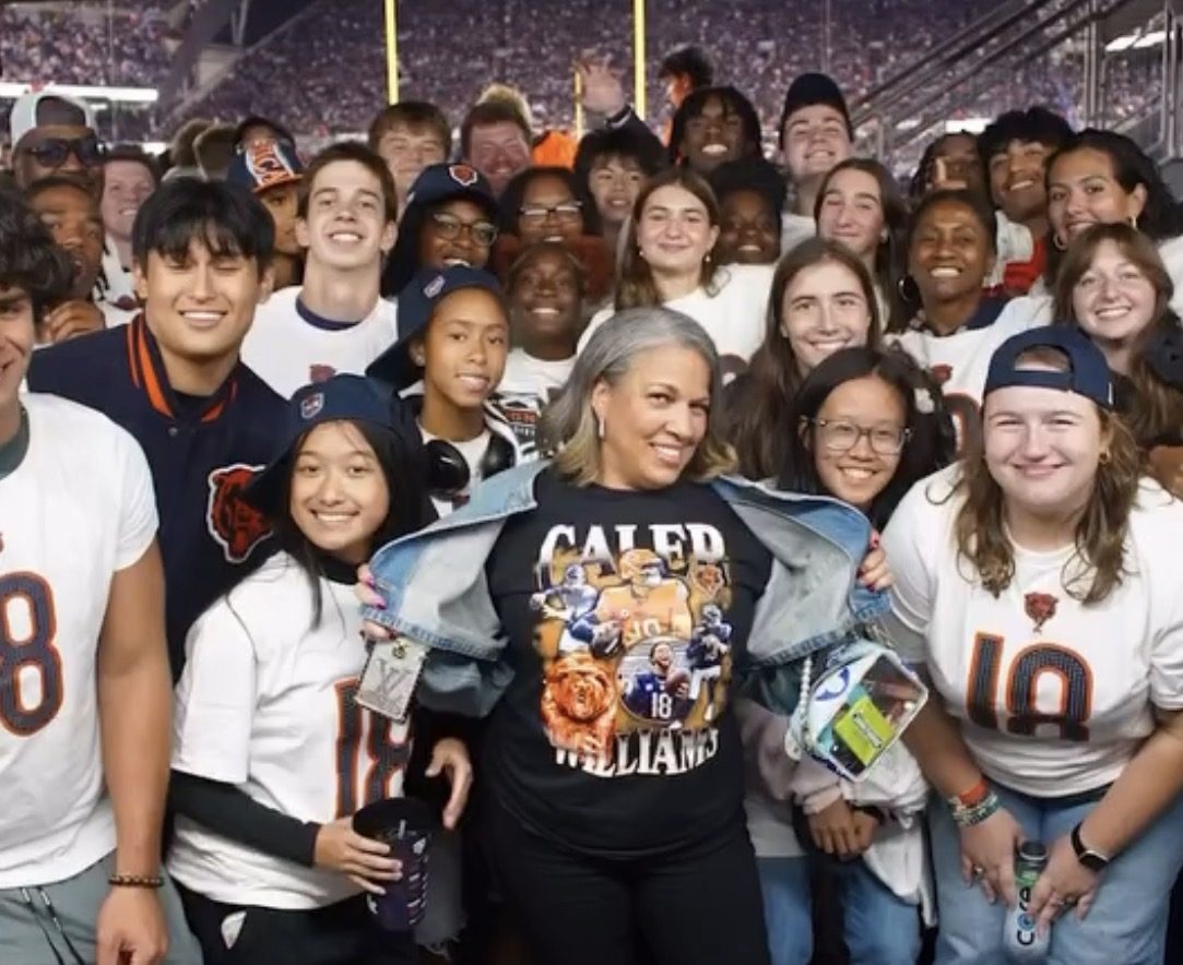 Fans wearing Caleb Williams gear at the stadium